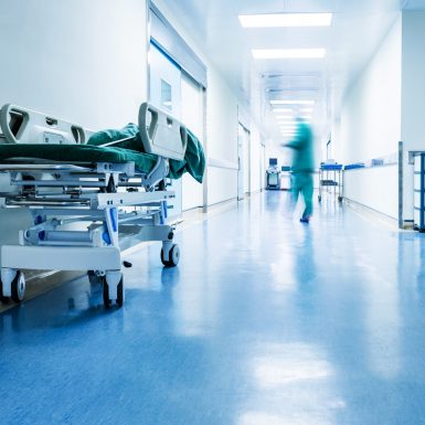 Doctors,Or,Nurses,Walking,In,Hospital,Hallway,,Blurred,Motion.